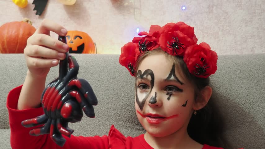 Kids trick or treat in Halloween costume. kids with a basket for sweets. A boy in a skeleton a girl in a witch costume. Children are having fun playing with balloons and laughing at holiday in autumn.