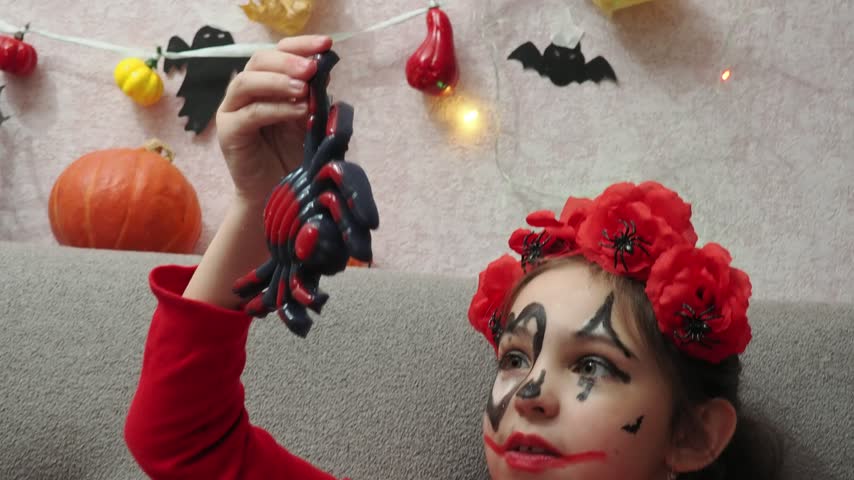 Kids trick or treat in Halloween costume. kids with a basket for sweets. A boy in a skeleton a girl in a witch costume. Children are having fun playing with balloons and laughing at holiday in autumn.