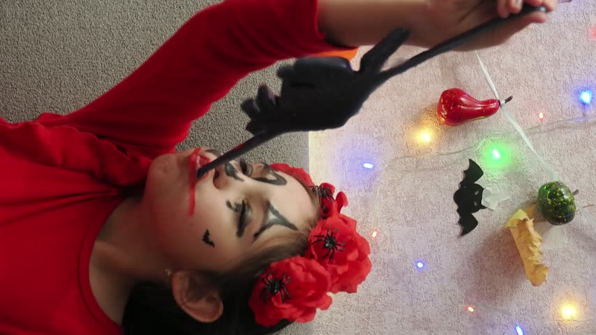 Kids trick or treat in Halloween costume. kids with a basket for sweets. A boy in a skeleton a girl in a witch costume. Children are having fun playing with balloons and laughing at holiday in autumn.
