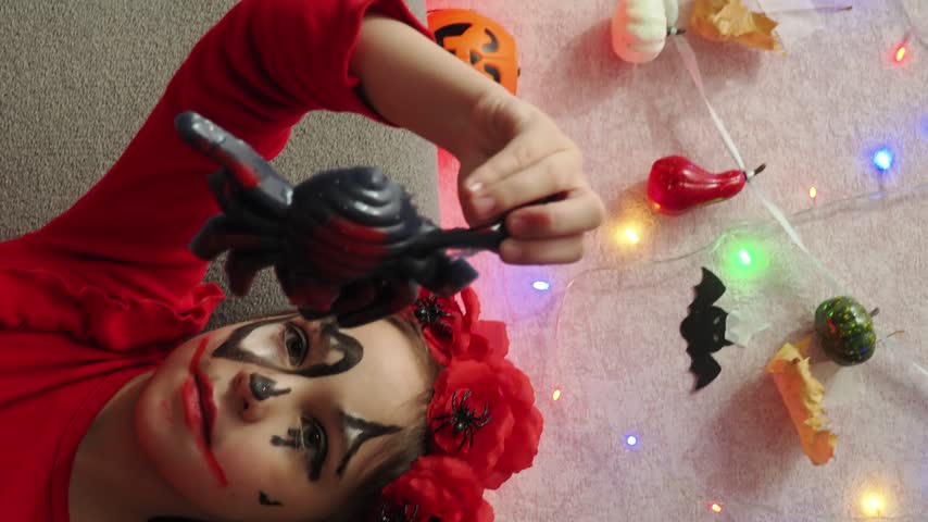 Kids trick or treat in Halloween costume. kids with a basket for sweets. A boy in a skeleton a girl in a witch costume. Children are having fun playing with balloons and laughing at holiday in autumn.