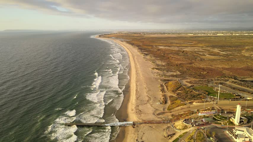 Aerial drone view of Playas de Tijuana coastline and Pacific Ocean waves in Baja California Mexico