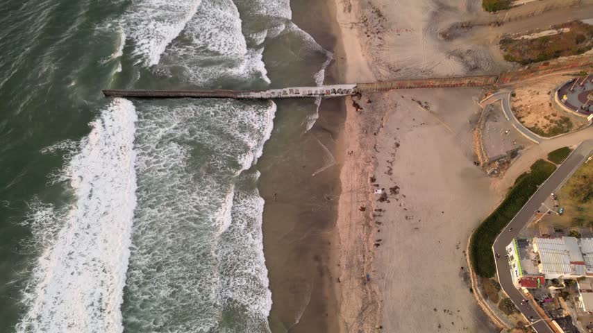 Aerial drone view of Playas de Tijuana coastline and Pacific Ocean waves in Baja California Mexico