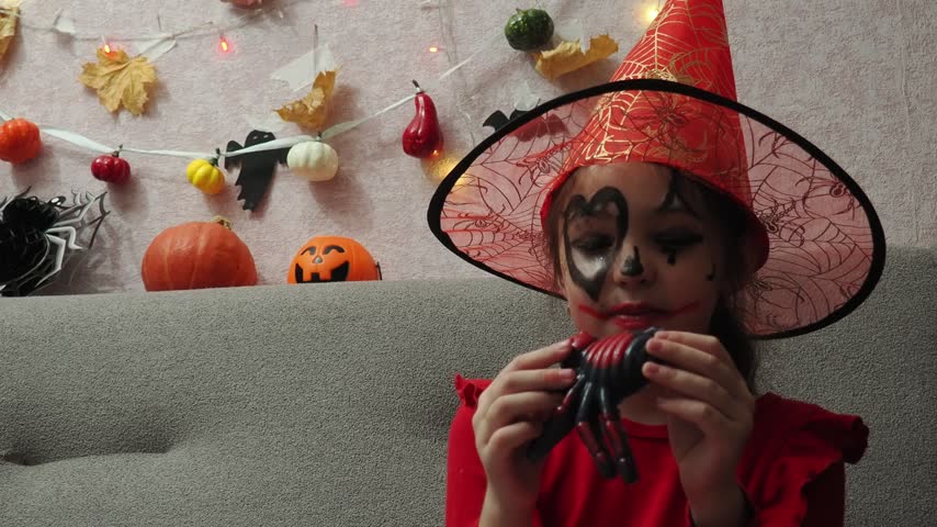 Kids trick or treat in Halloween costume. kids with a basket for sweets. A boy in a skeleton a girl in a witch costume. Children are having fun playing with balloons and laughing at holiday in autumn.