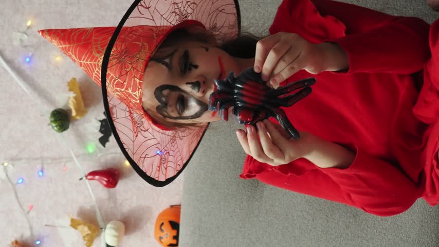 Kids trick or treat in Halloween costume. kids with a basket for sweets. A boy in a skeleton a girl in a witch costume. Children are having fun playing with balloons and laughing at holiday in autumn.