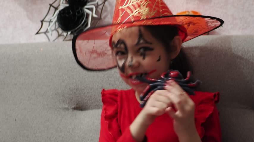 Kids trick or treat in Halloween costume. kids with a basket for sweets. A boy in a skeleton a girl in a witch costume. Children are having fun playing with balloons and laughing at holiday in autumn.