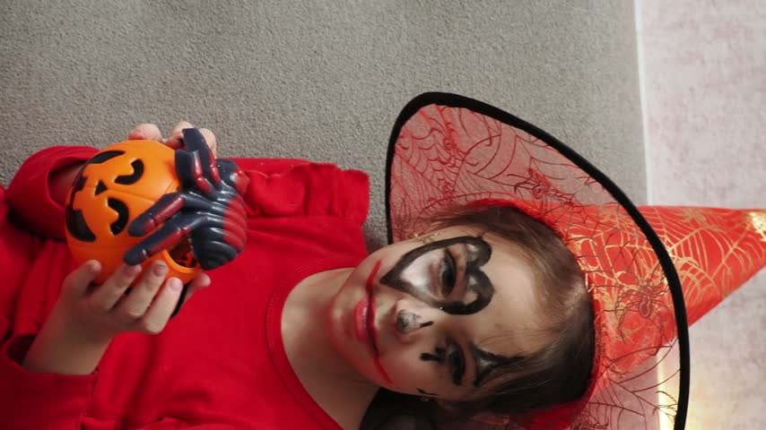 Kids trick or treat in Halloween costume. kids with a basket for sweets. A boy in a skeleton a girl in a witch costume. Children are having fun playing with balloons and laughing at holiday in autumn.