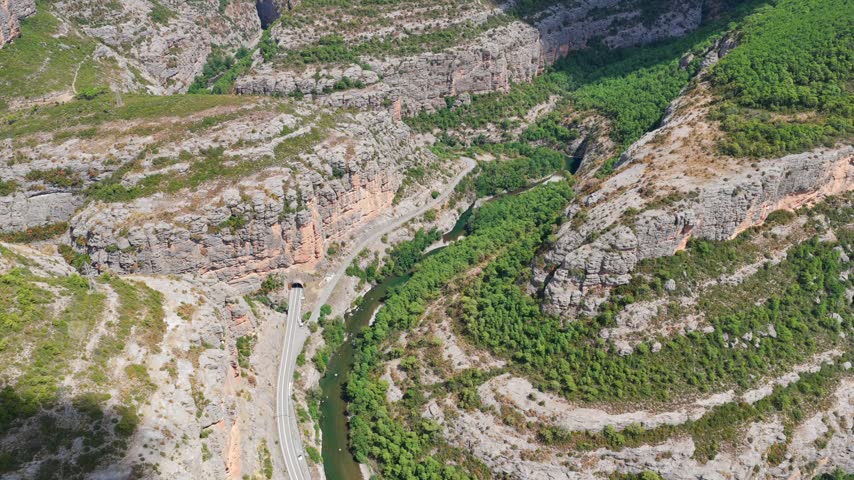 Aerial panorama of Congost de Collegats canyon with Noguera Pallaresa river and mountain road tunnels, Catalonia, Spain