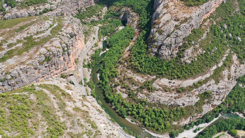 Aerial panorama of Congost de Collegats canyon with Noguera Pallaresa river and mountain road tunnels, Catalonia, Spain