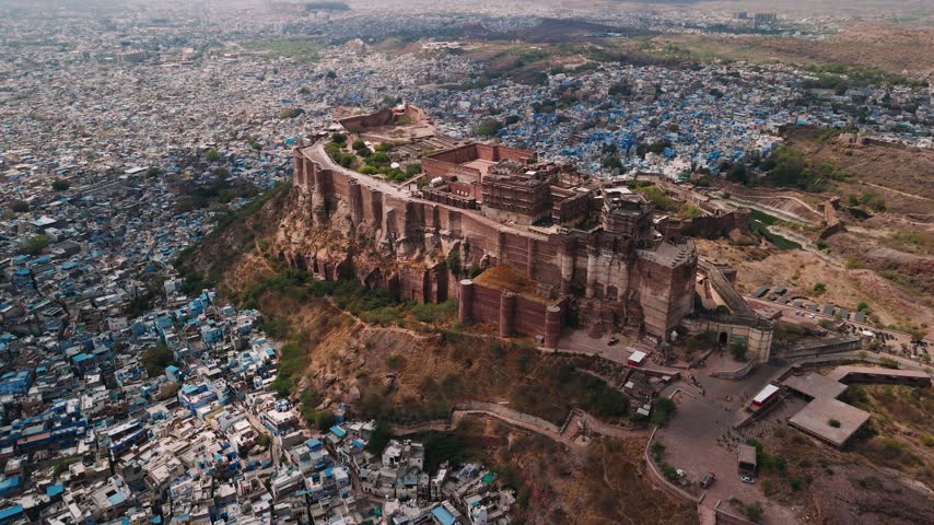 Aerial view of mehrangarh fort towering above the blue city of jodhpur, rajasthan, india, a popular historic destination.
