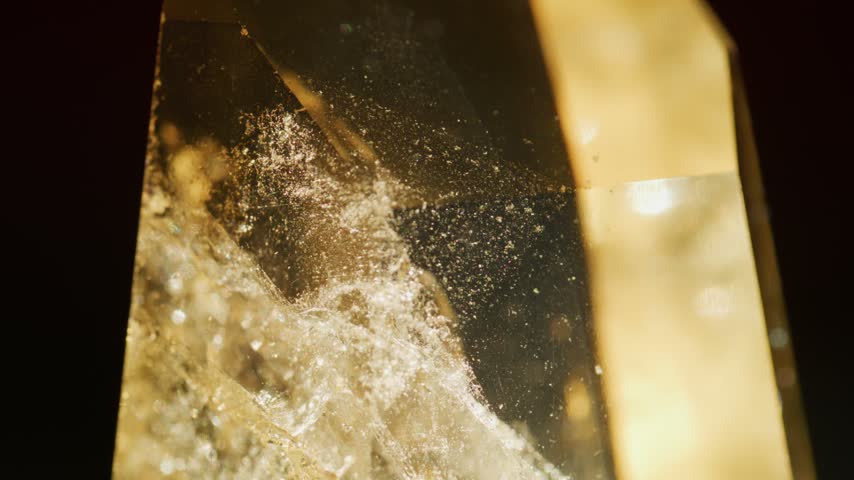 Macro Smoky Quartz Crystal Rotating in Mottled Sunlight, Extreme Close Up Slow Motion