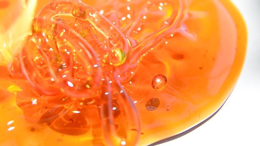honey flowing on a white background, Extreme close up