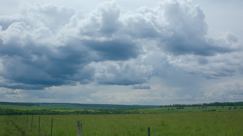 A Beautiful Overcast Landscape Featuring Lush Green Fields and Expansive Skies Above