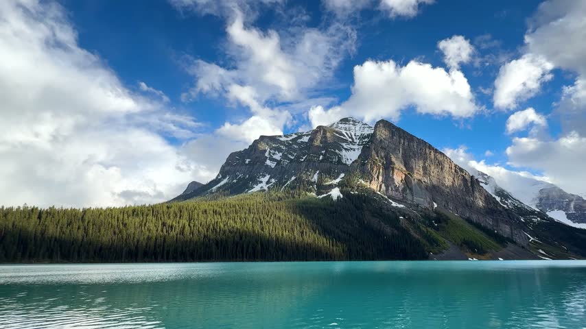 Lake Louise reflects mountains and trees at Banff National Park in Canada