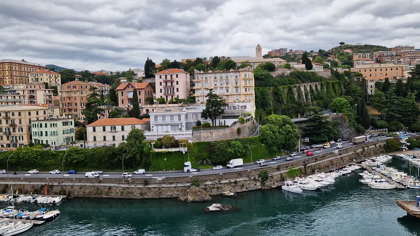 POV from cruise ship balcony looking at the scenic coast and colorful buildings of Savona, Italy