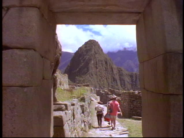 PERU, 1998, Machu Picchu, Peru, The Andes, medium shot through gate with people, shot on Eastman Kodak film