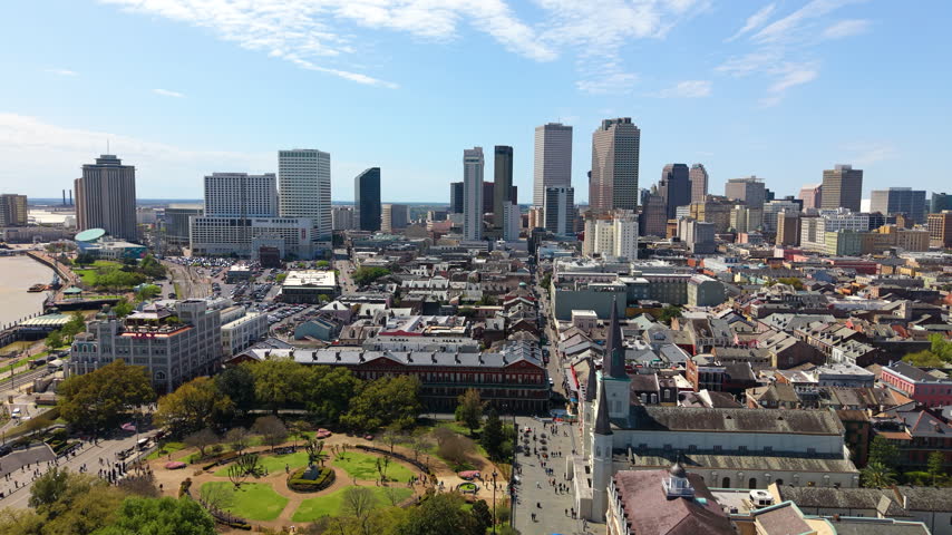 Scenic aerial view of New Orleans featuring the French Quarter, downtown skyline and Mississippi River. Historic architecture contrasts beautifully with modern office towers and hotels.
