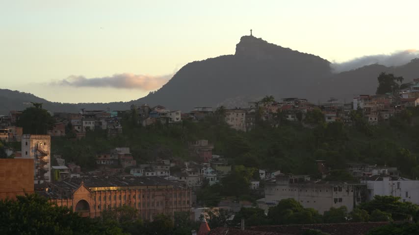 Rio de Janeiro, Brazil Sunset View From Cruise Ship. Christ the Redeemer Statue on Mountain. Warm Light, Colorful Clouds Roll In, City Buildings.