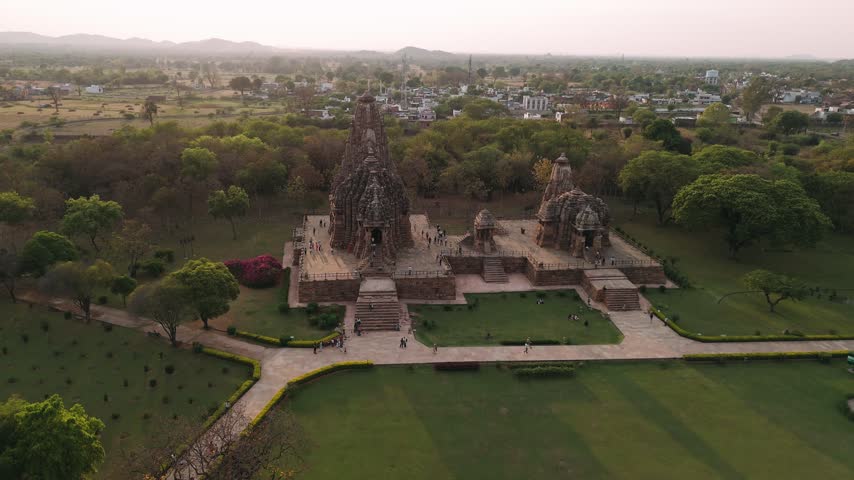 Aerial view of the historic khajuraho temples in india with tourists visiting the ancient monument.