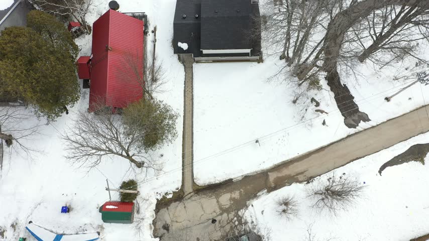Elevated Panorama of Snow Covered Lakeside Homes in Winter.
