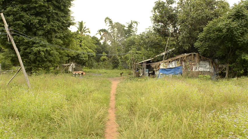 A path leading to a rundown house in rural Thailand.