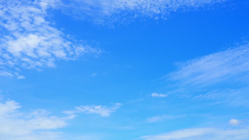 A blue sky cloud timelapse video showing scattered cirrocumulus and altocumulus clouds drifting across a vivid sunny sky, capturing gentle air movement, changing weather, and peaceful nature.
