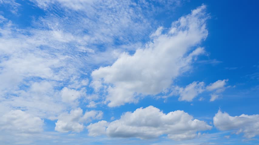 A blue sky cloud timelapse video showing towering cumulus and textured altocumulus clouds moving across a vivid sunlit sky, capturing dynamic airflow, changing weather, and bright daytime atmosphere.
