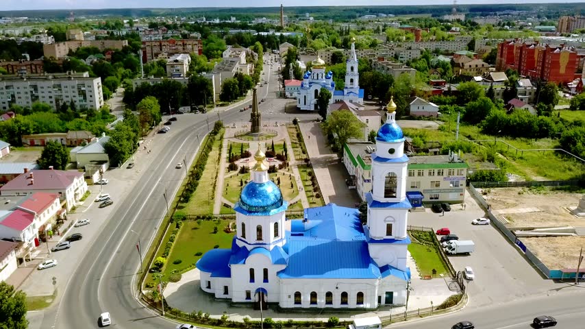 Aerial view of a beautiful Russian Orthodox church with iconic blue domes in a quiet provincial town.