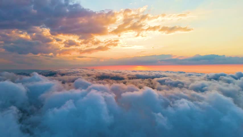 This breathtaking 6K ultra-high-definition timelapse hyperlapse video presents a mesmerizing, accelerated aerial perspective, soaring dynamically across a vast, rolling ocean of dense white and grey clouds as the sun descends toward the horizon during a brilliant sunset. The dramatic upper atmosphere overhead evolves rapidly, glowing with vibrant amber light, rich golden hues, and intense fiery orange gradients that cast shifting reflections across the undulating vapor blanket below. The accelerated hyperlapse motion creates an extraordinary sense of high-speed travel, weightless elevation, and fluid transition, drawing the viewer into a dynamic and hypnotic journey high above the natural world. Every fast-moving cloud puff, shifting shadow, and sunlit crest is rendered with exceptional cinematic clarity, ultra-sharp detail, and rich atmospheric depth, highlighting the grand scale of the upper troposphere. Designed specifically to meet the rigorous professional demands of high-end commercial, corporate, and editorial motion projects, this versatile 6K video asset is perfectly suited for time-compressed background loops, weather broadcasts, aviation features, travel documentaries, and modern digital website headers. The fluid hyperlapse movement and balanced natural color palette provide multimedia producers, video editors, and digital creators with an impactful storytelling tool that communicates universal themes of rapid change, boundless exploration, clarity, and the majestic beauty of the sky. Whether utilized to establish a dynamic corporate atmosphere or to evoke a sense of high-altitude motion, this captivating footage delivers a polished, premium aesthetic that enhances any creative visual production.