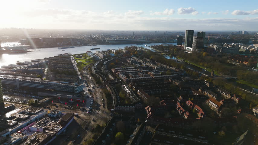 Aerial view overlooking the IJ river and modern city skyline in Amsterdam.