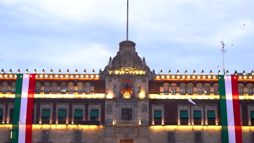 The National Palace of Mexico in the Zocalo Square illuminated and decorated at dusk