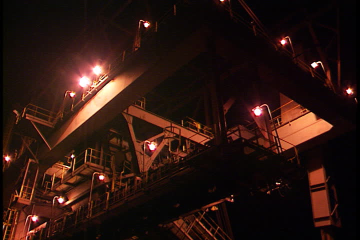 Tilt down from Rockport River Terminal to belt conveyor, about to scoop up coal from barge in Rockport, Indiana.
