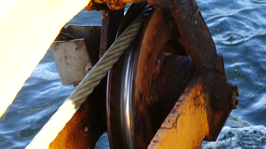 Stockholm, Sweden An industrial pulley and a metal cable over the Baltic Sea used to pull a small Stockholm archipelago ferry across a sound.  