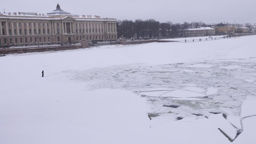 Winter landscape of frozen Neva River in capital of Russia St. Petersburg. Imperial residence of magnificent Russian Empire classical architecture. Vasilyevsky Island, Academy of Arts