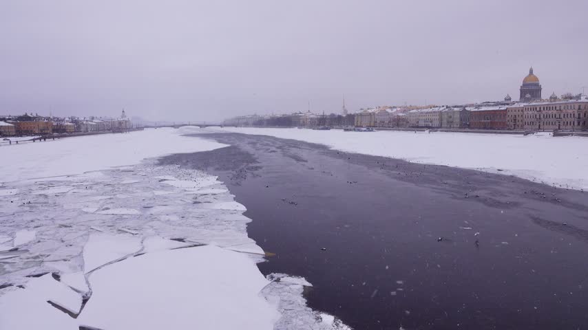 Winter landscape of frozen Neva River in capital of Russia St. Petersburg. Imperial residence of magnificent Russian Empire classical architecture. Admiralteiskaya embankment and Vasilyevsky Island