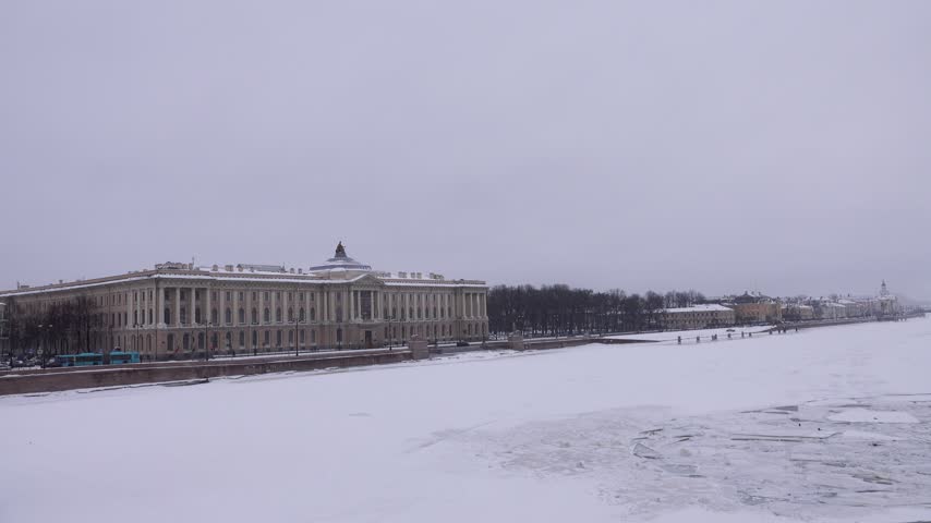 Winter landscape of frozen Neva River in capital of Russia St. Petersburg. Imperial residence of magnificent Russian Empire classical architecture. Vasilyevsky Island, Academy of Arts