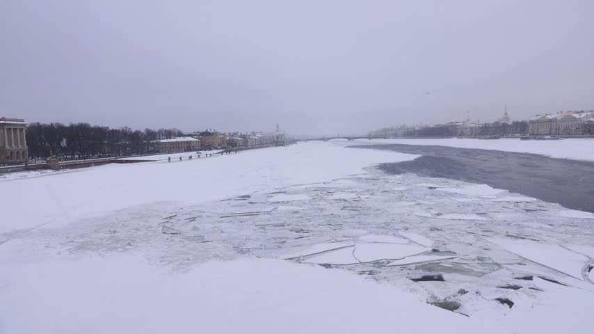 Winter landscape of frozen Neva River in capital of Russia St. Petersburg. Imperial residence of magnificent Russian Empire classical architecture. Admiralteiskaya embankment and Vasilyevsky Island