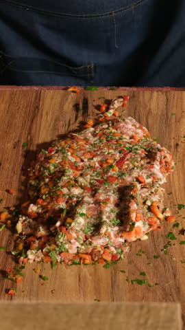 Professional cook preparing a traditional Turkish Adana Kebab recipe with a large zırh knife