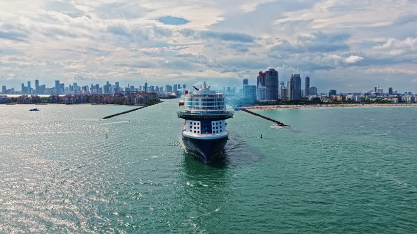Ship leaving Miami port in Florida. Miami tour. Cruise ship voyage. Aerial view of cruise in summer vacation. Cruise ship tour and travel at sea. Aerial view of luxury liner voyage