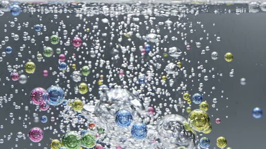 Colorful Abstract Bubbles Rising in Clear Water with Sparkling Air Droplets Macro Background