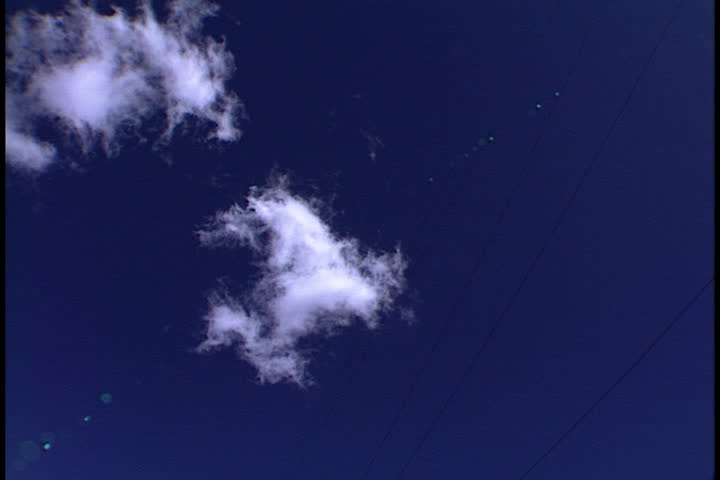 Camera twists from blue sky to low angle of transmitter tower in Hilo, Hawaii.