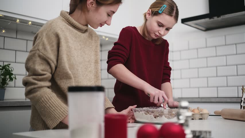 Sisters Bake Gingerbread Cookies For Christmas, Mixing Dough Thoroughly For Perfect Festive Treats