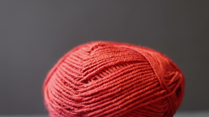 Hands holding red yarn and a crochet hook, crafting detail. hands, 
