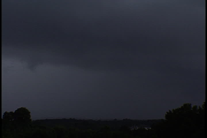Dark, low hanging storm clouds over open field in Atlanta, Georgia.