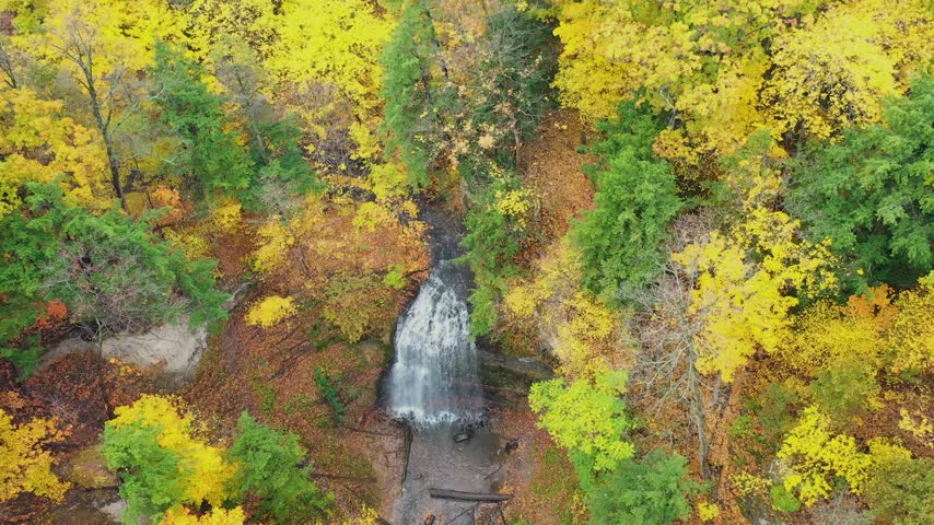 Aerial View of Waterfall Surrounded by Autumn Forest in Ontario Canada
