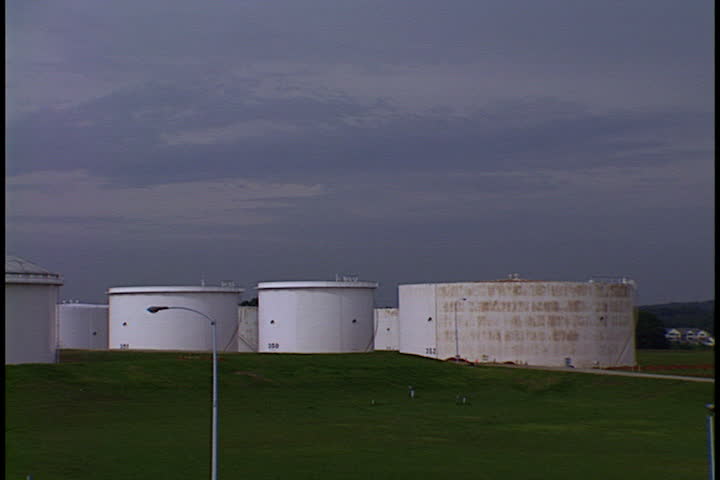ATLANTA, GEORGIA - JUNE 30, 1999: Pan across field of oil storage tanks.