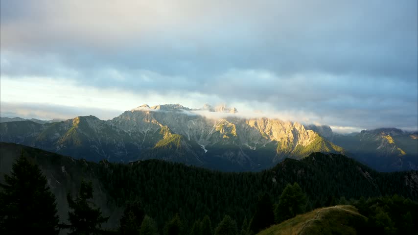 Sunrise timelapse from Trupejevo Poldne peak of clouds flying over Julian Alps