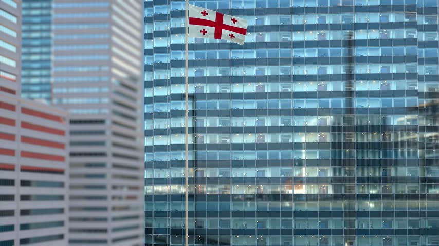 Georgia Flag Waving Against Glass Office Building - Daylight Scene