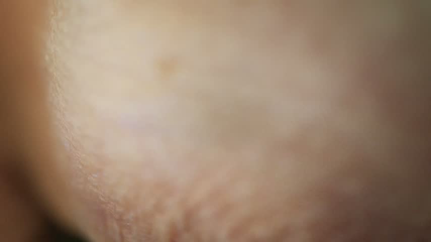 Macro close-up of a human eye reflecting colorful festive Christmas lights within the iris and pupil.