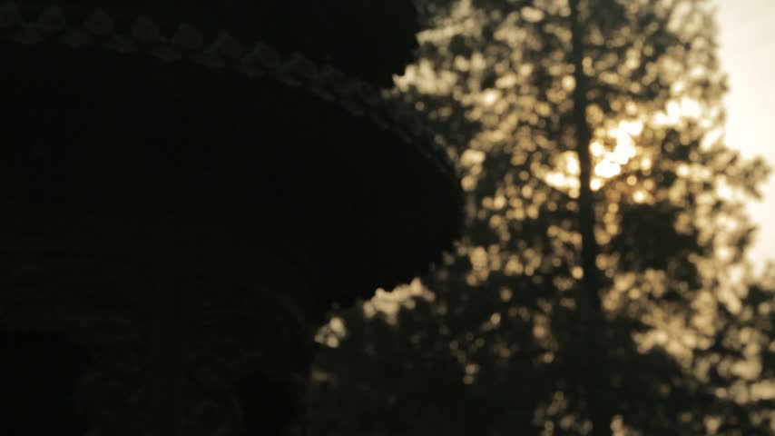 Sunlight Shining Through Trees and Temple Architecture at Lama Temple, Beijing