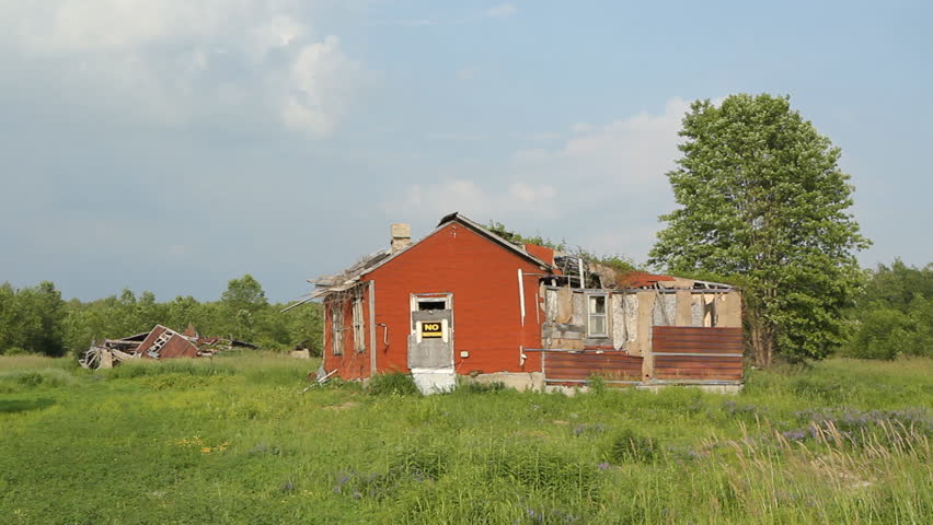 Abandoned rural house.
Abandoned house in field, with broken structure in the distance. Ontario, Canada. 
